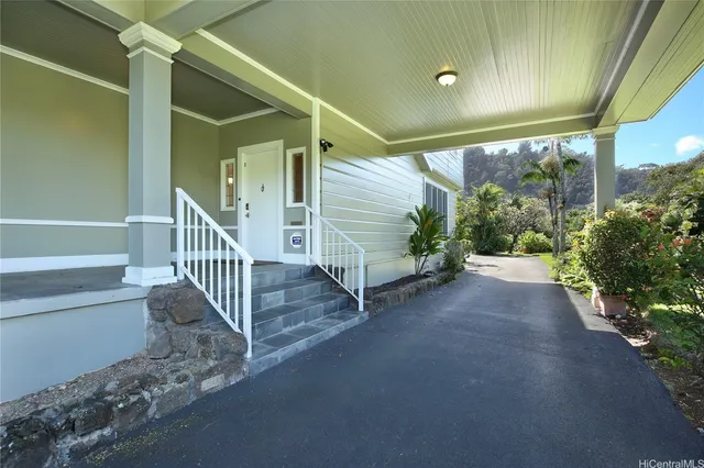 a view of a porch with wooden floor and door