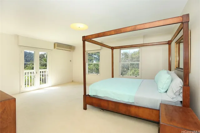 a bed sitting in a spacious bedroom next to a window