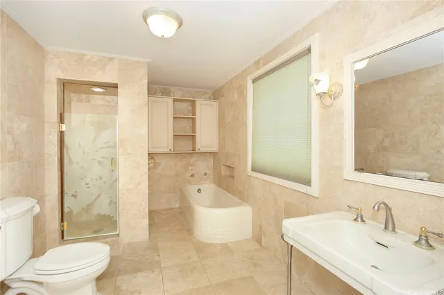 a bathroom with a sink toilet tub and shower