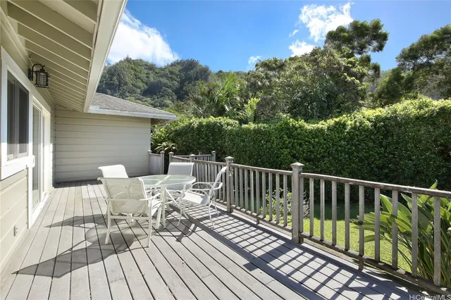 a view of balcony with wooden floor and outdoor seating