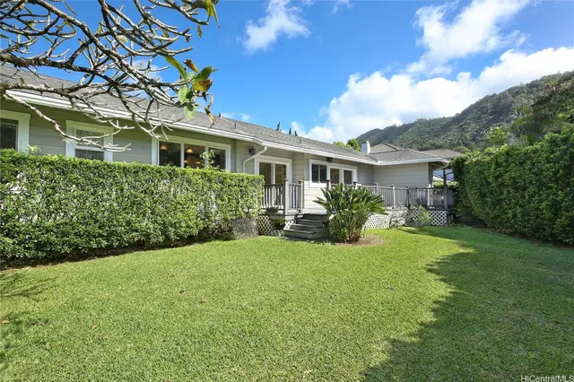 a front view of a house with yard and green space