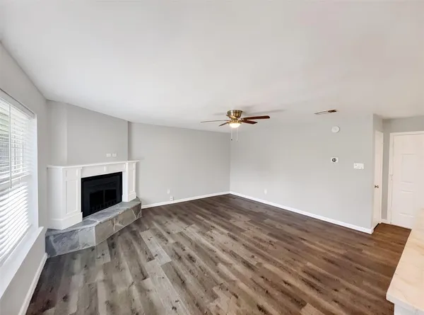 a view of empty room with a fireplace