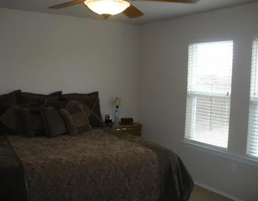 a bed sitting in a bedroom next to a window