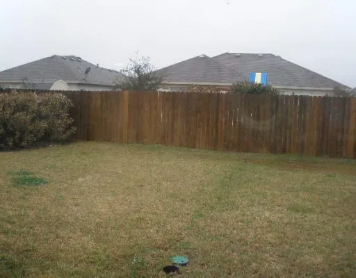 a view of a house with a yard next to a yard