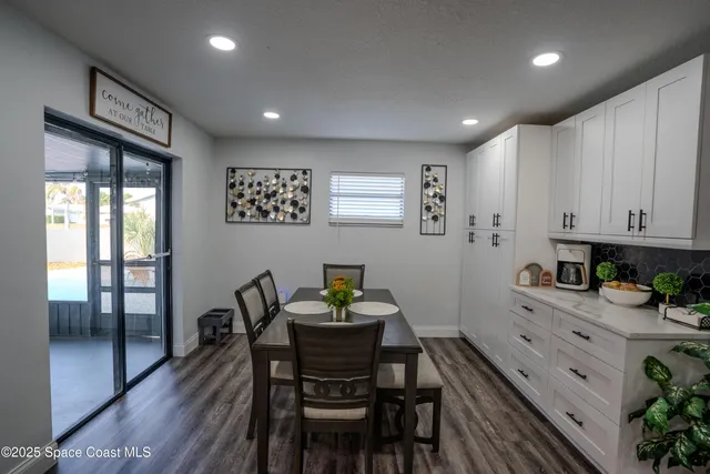 a kitchen with a table and chairs in it