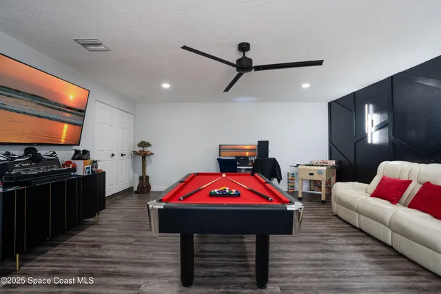a living room with furniture flat screen tv and rug
