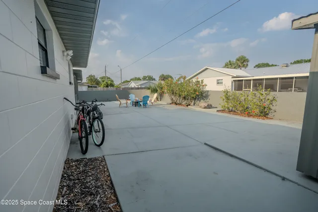 a backyard of a house with table and chairs