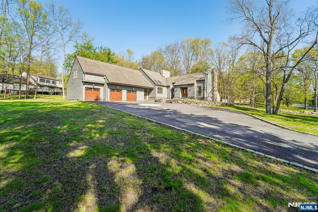 11 Carlough Road Upper Saddle River, NJ 07458 - Photo 4 of 41 a front view of a house with a garden