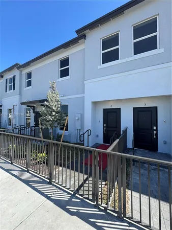 a view of a house with wooden fence
