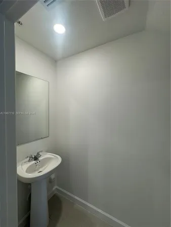 a bathroom with a sink a mirror and a toilet