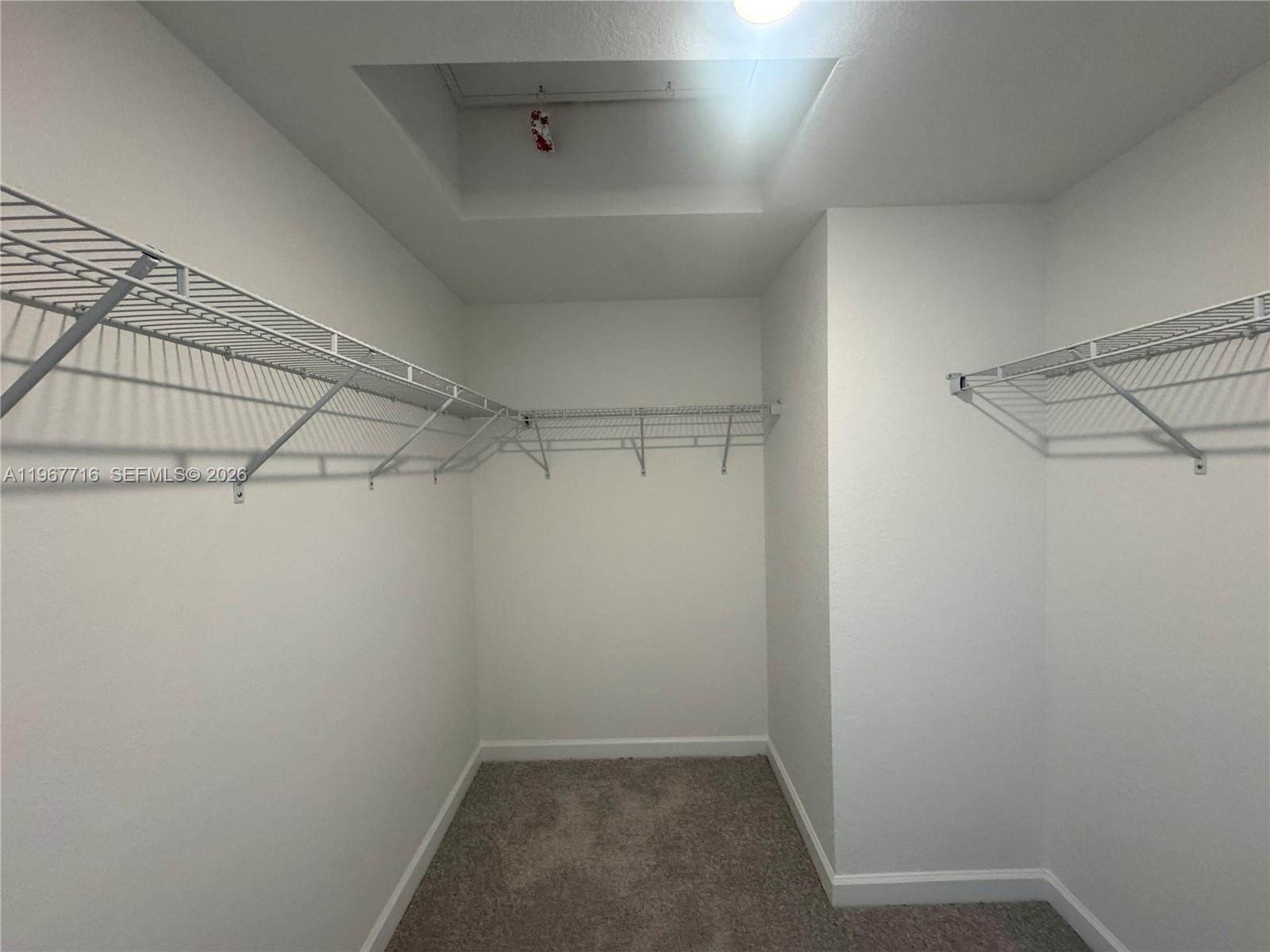 12420 Southwest 248th Street, Unit 4 Homestead, FL 33032 - Photo 15 of 20 a view of a room with racks on the wall