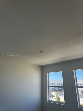 a view of an empty room with a window