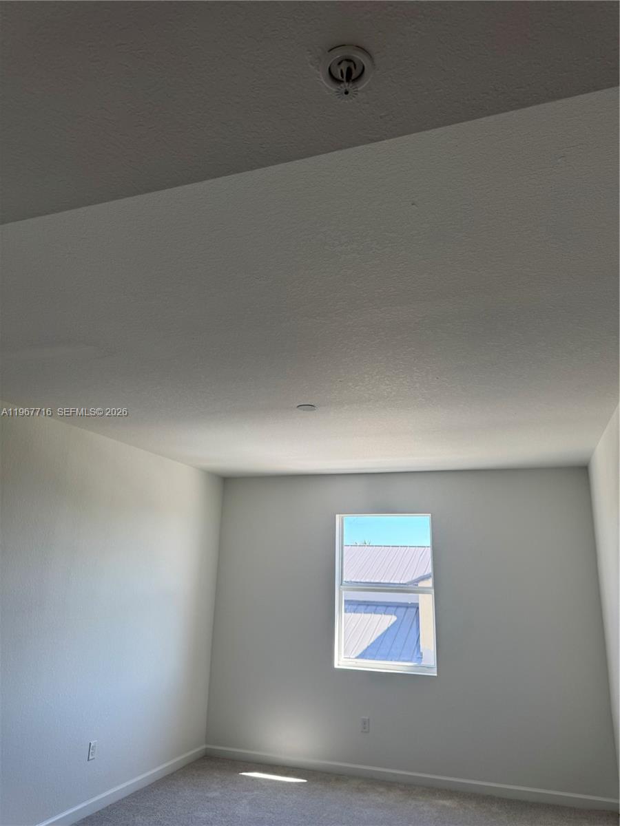12420 Southwest 248th Street, Unit 4 Homestead, FL 33032 - Photo 19 of 20 an empty room with windows