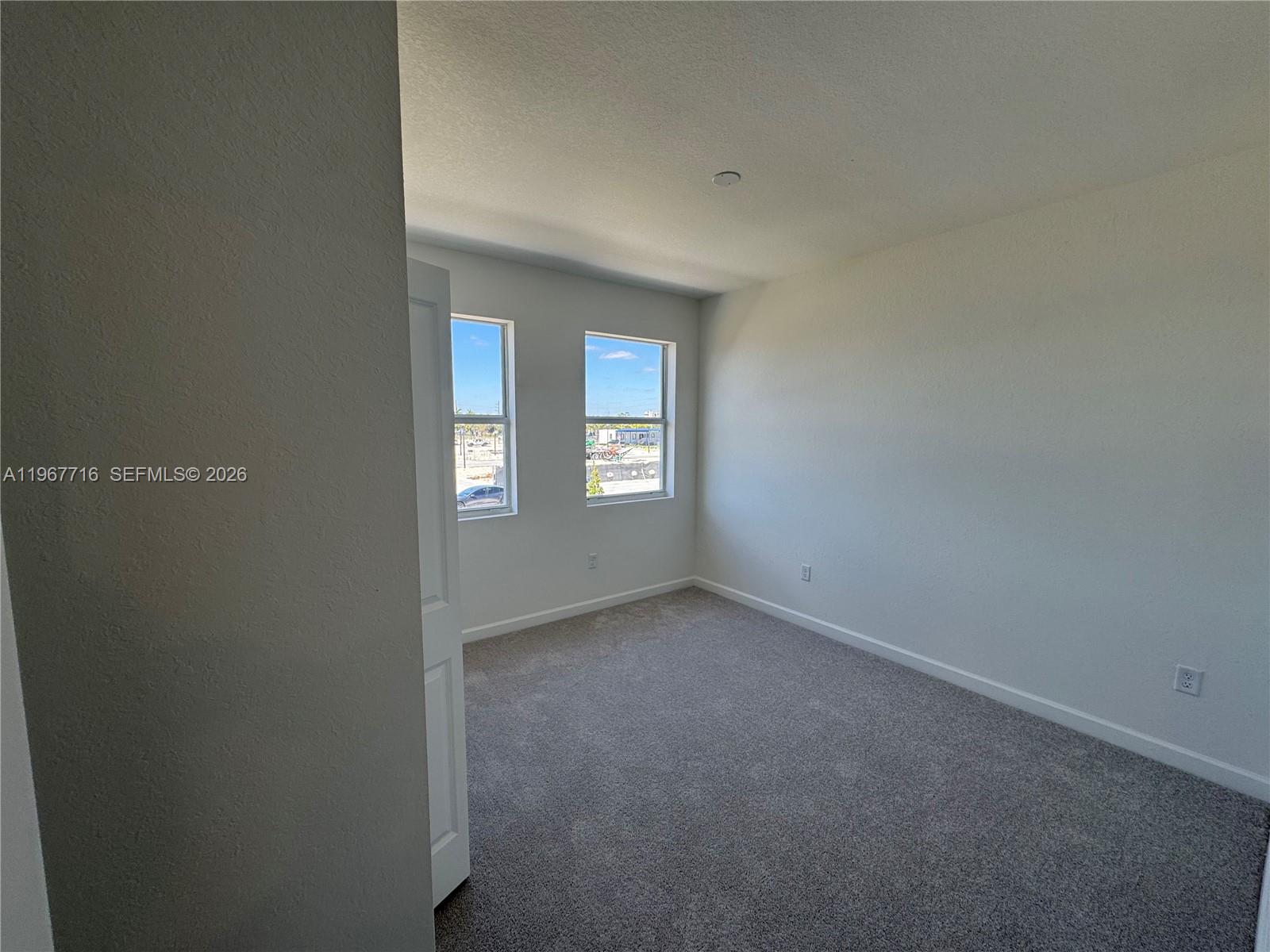 12420 Southwest 248th Street, Unit 4 Homestead, FL 33032 - Photo 2 of 20 a view of an empty room with window