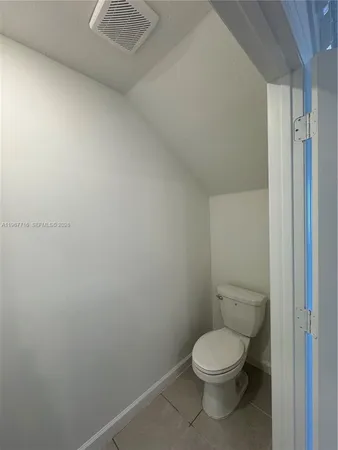 a white toilet sitting next to a shower
