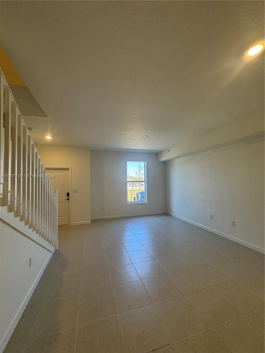 12420 Southwest 248th Street, Unit 4 Homestead, FL 33032 - Photo 6 of 20 an empty room with a empty space and windows