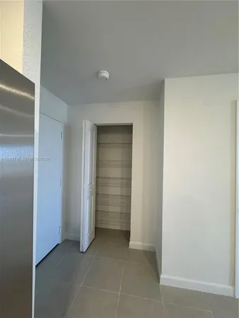 a view of an empty room and closet area