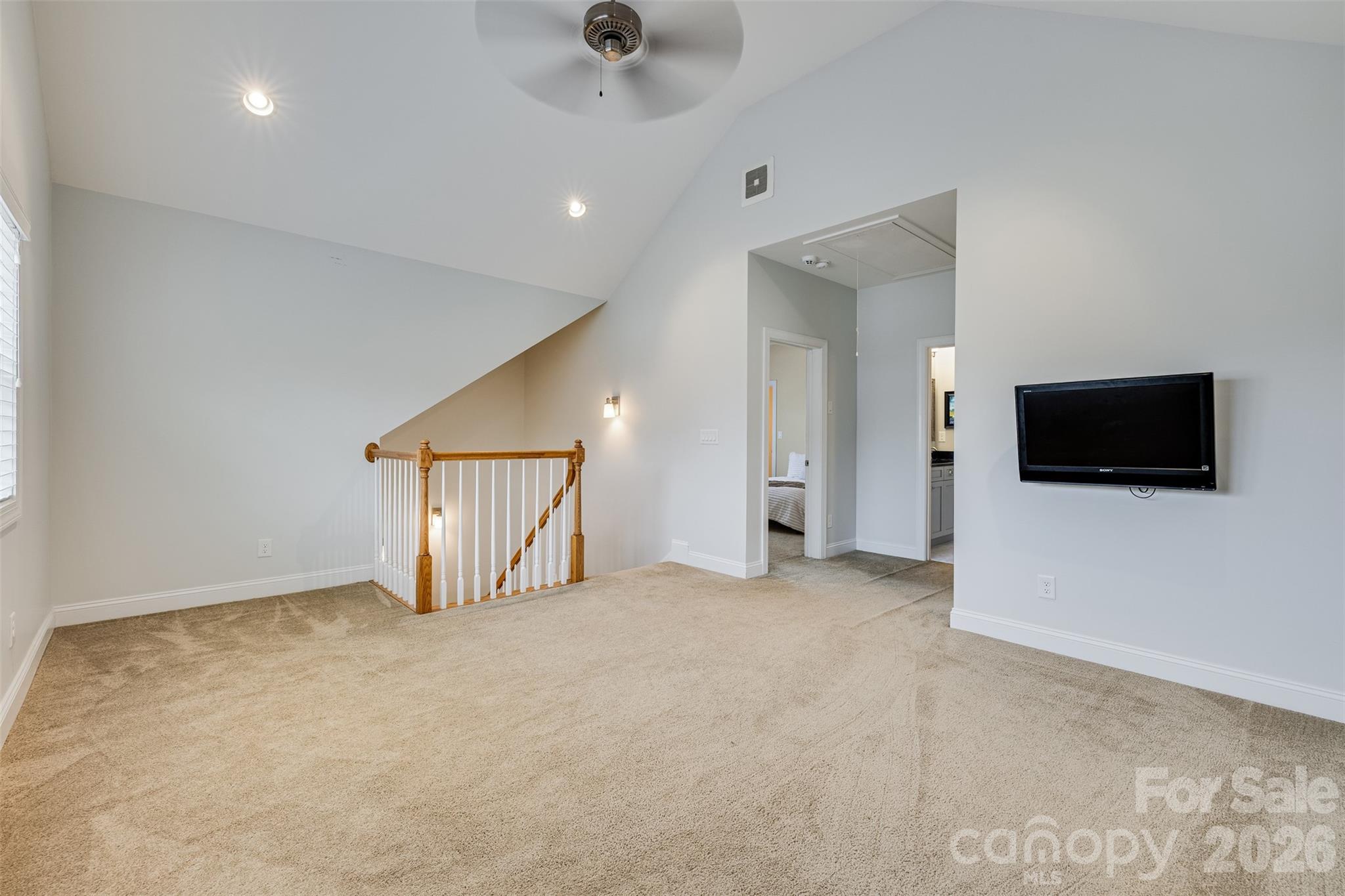 104 Meyers Ridge Road Cramerton, NC 28032 - Photo 21 of 36 an empty room with a flat tv screen and a projector