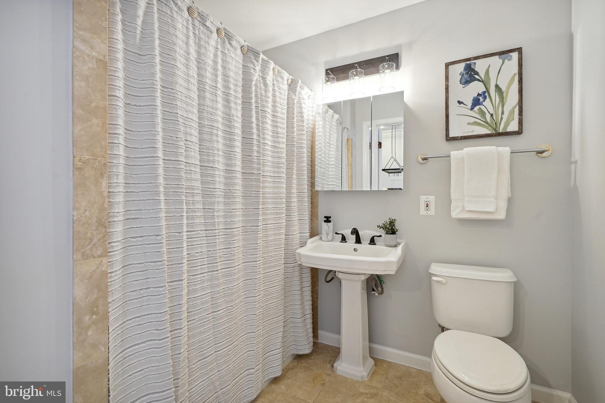 1520 O Street Northwest, Unit T8 Washington, DC 20005 - Photo 14 of 20 Marble bath with new vanity with light fixture