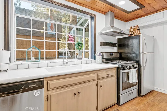 a kitchen with stainless steel appliances granite countertop a stove and a refrigerator