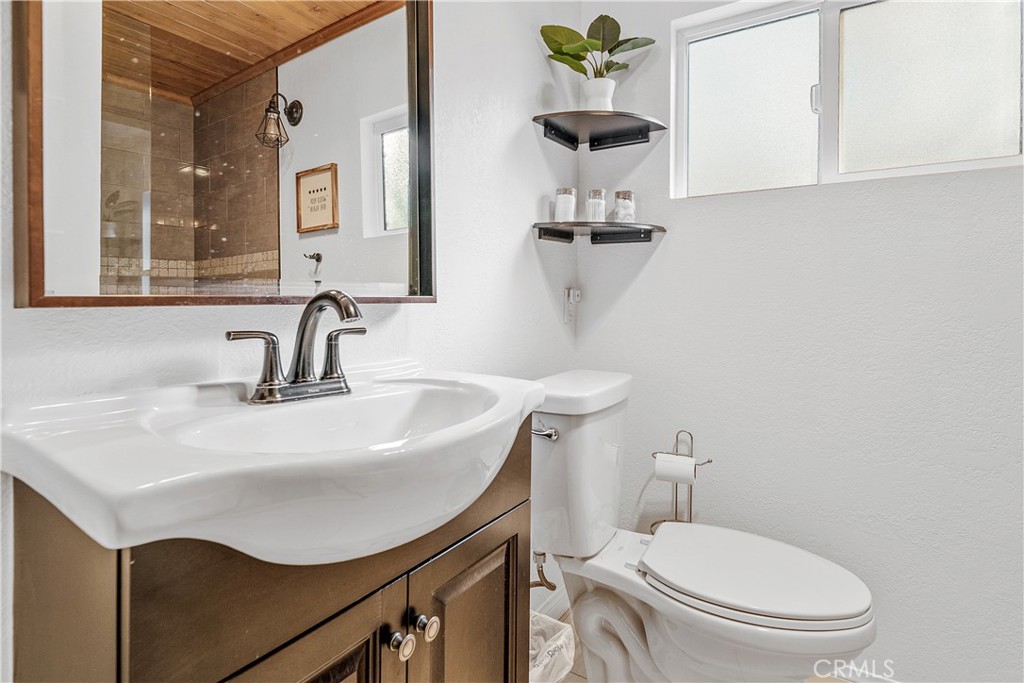 660 Barrett Way Big Bear City, CA 92314 - Photo 16 of 32 a bathroom with a toilet sink and mirror