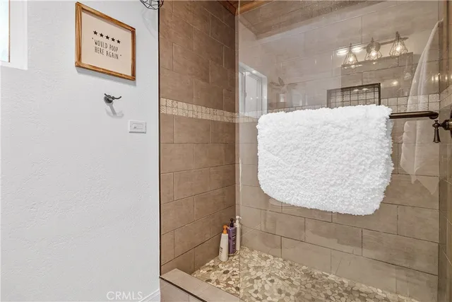 a bedroom with a bed a window and a flat screen tv