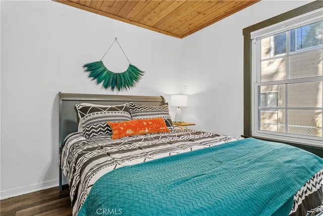 a bed sitting in a bedroom next to a window