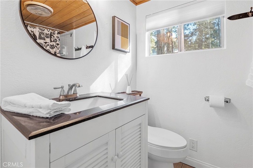 660 Barrett Way Big Bear City, CA 92314 - Photo 25 of 32 a bathroom with a granite countertop sink and a mirror