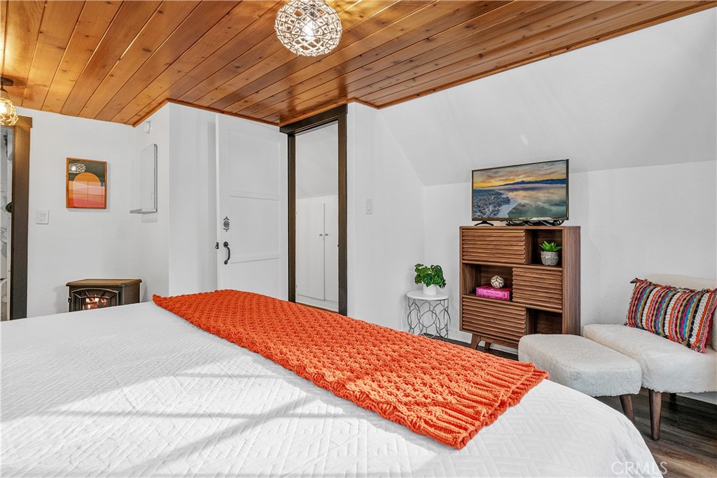 660 Barrett Way Big Bear City, CA 92314 - Photo 29 of 32 a bedroom with a bed and a bookshelf