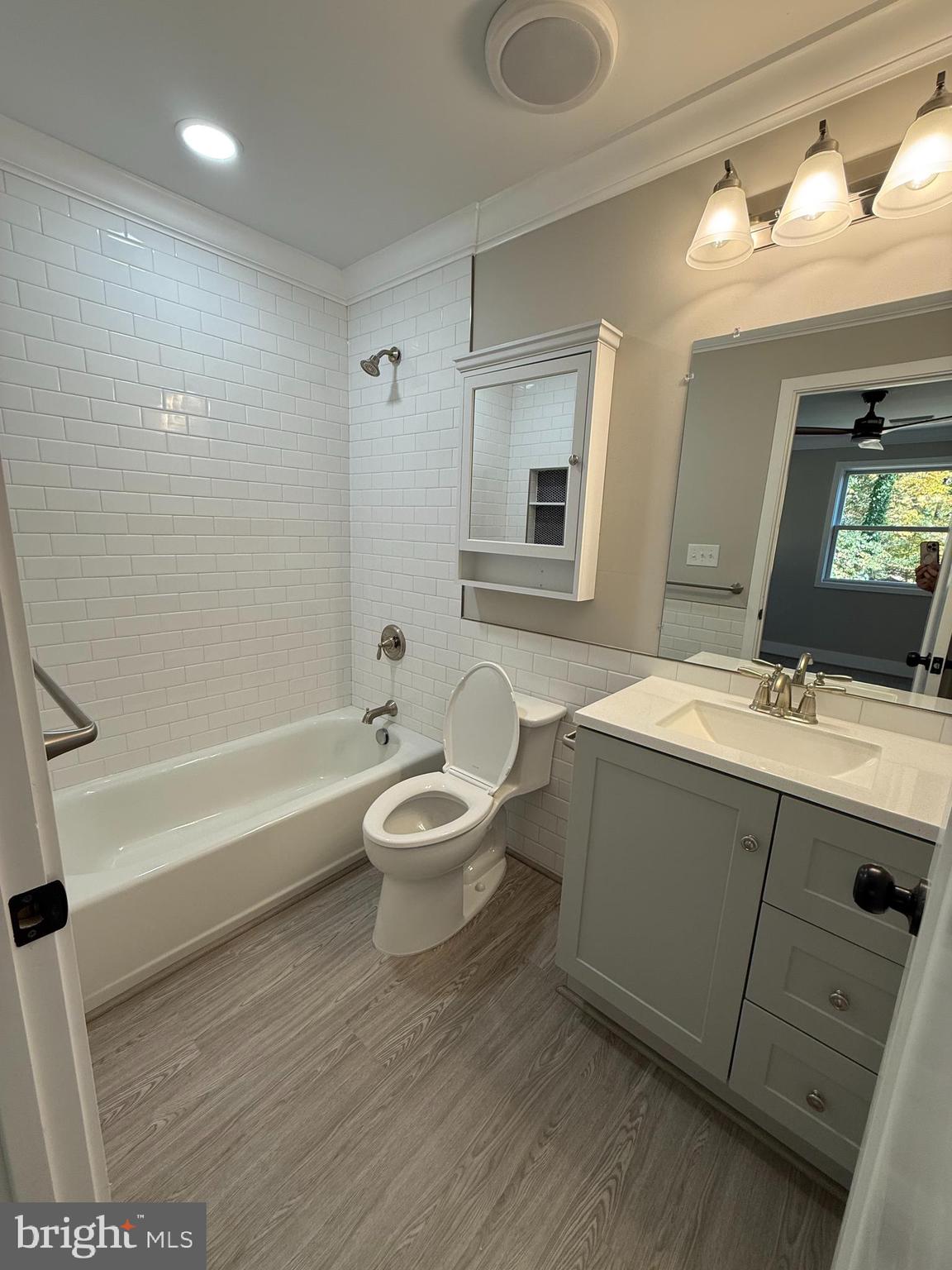 453 Walnut Drive Edgewater, MD 21037 - Photo 11 of 46 a bathroom with a sink toilet a mirror and bathtub