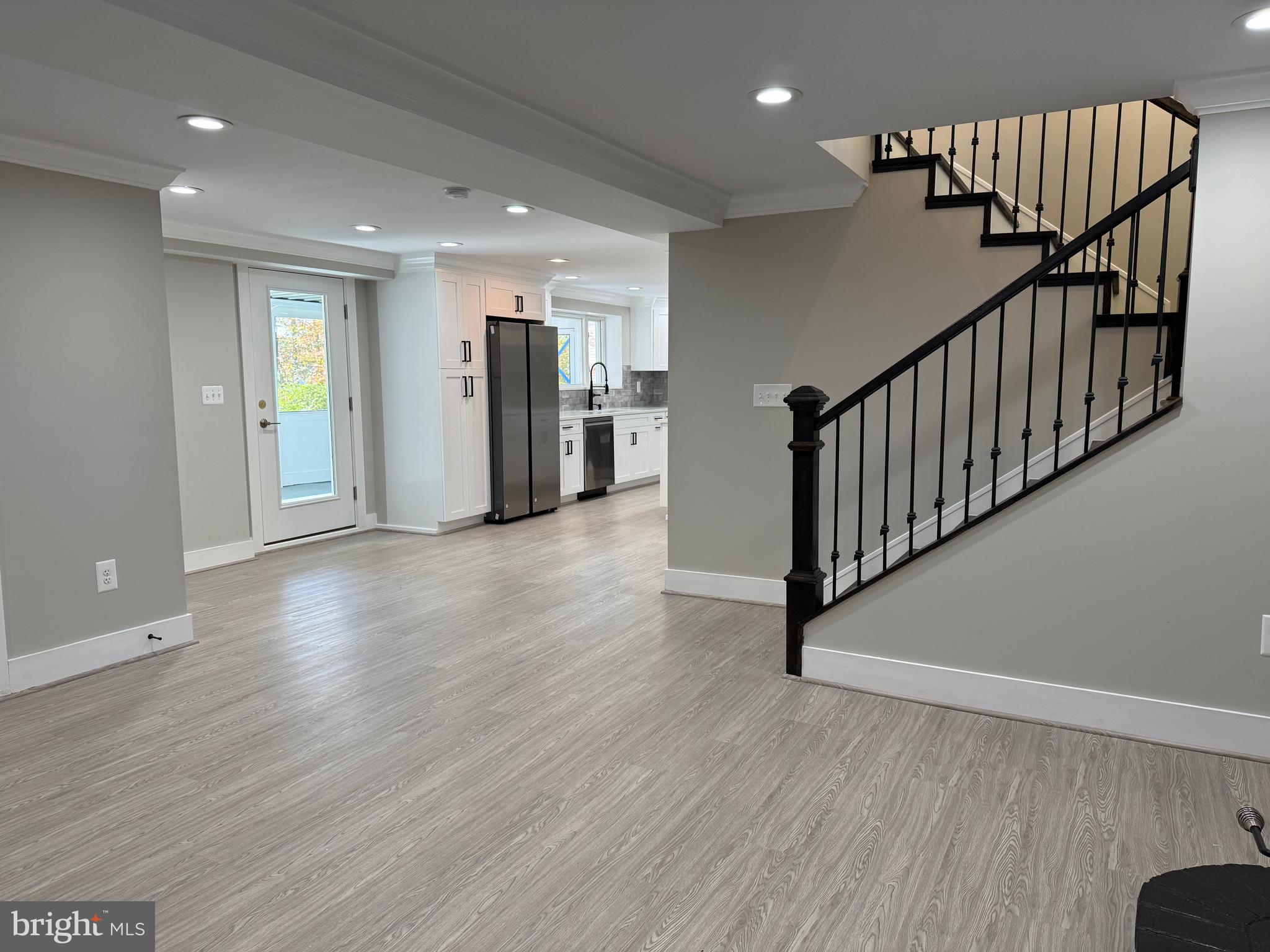 453 Walnut Drive Edgewater, MD 21037 - Photo 3 of 46 a view of a hallway with wooden floor and staircase