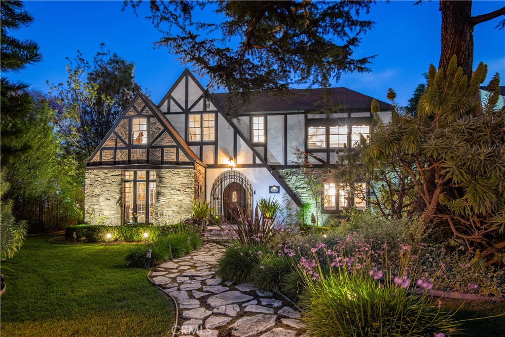 a front view of a house with garden