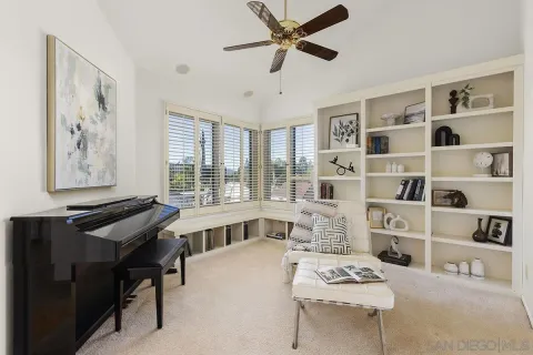 a kitchen with cabinets and chairs