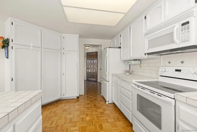 a bedroom with a large bed and a flat screen tv