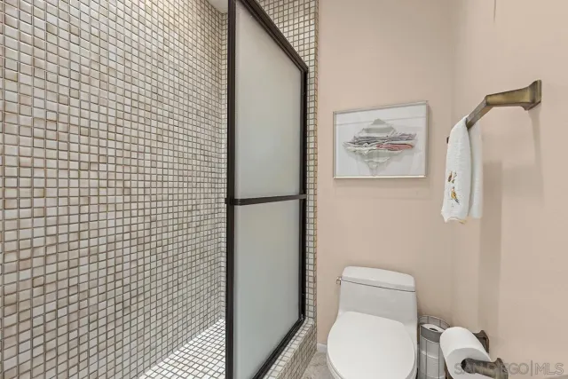 a view of a garden with a lot of flower plants and wooden fence