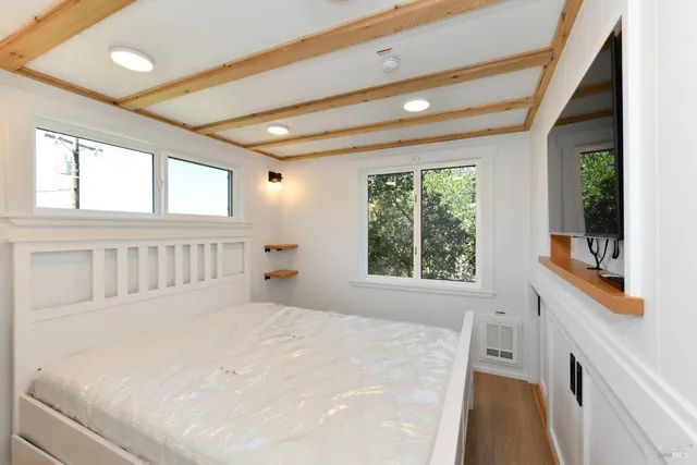 a large white bed in a white room