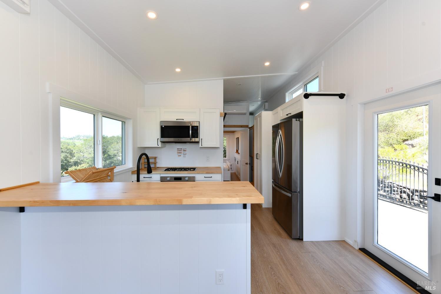 1033 Sundown Trail Santa Rosa, CA 95404 - Photo 34 of 45 a kitchen with sink a refrigerator and microwave