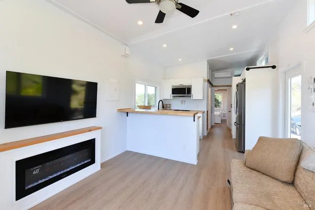 a view of kitchen with microwave stove refrigerator and oven