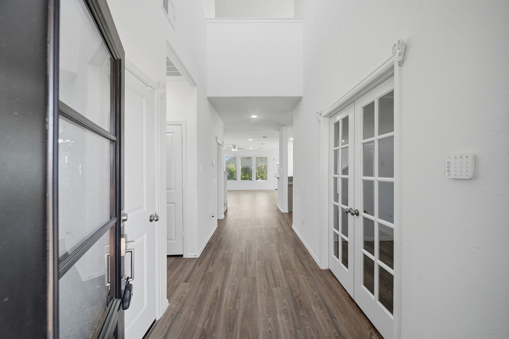 14230 Overbrook Willow Way Rosharon, TX 77583 - Photo 4 of 50 a view of a hallway with wooden floor and staircase