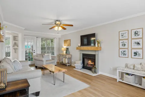a living room with furniture a fireplace and a flat screen tv