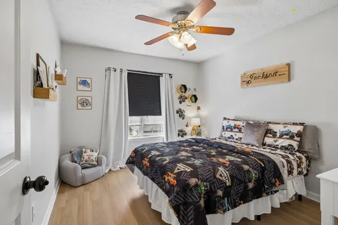 a bedroom with bed and a chandelier
