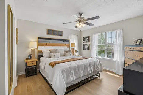 a bedroom with a large bed and a window