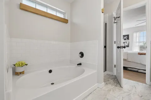 a bathroom with a bathtub and a shower