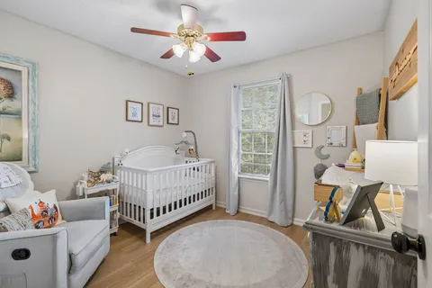a view of a bedroom with furniture and wooden floor