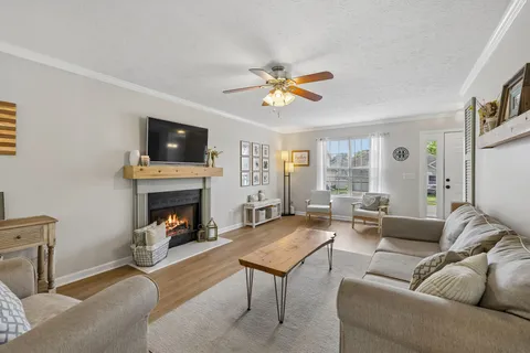 a living room with furniture a fireplace and a flat screen tv