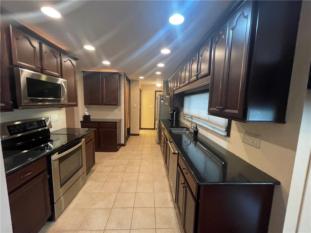 628 Saxonburg Road Butler, PA 16002 - Photo 17 of 46 a kitchen with stainless steel appliances granite countertop a refrigerator a stove top oven a sink and dishwasher