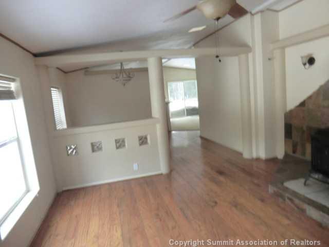865 Silver Creek Road Idaho Springs, CO 80452 - Photo 2 of 11 a view of an empty room with a fireplace