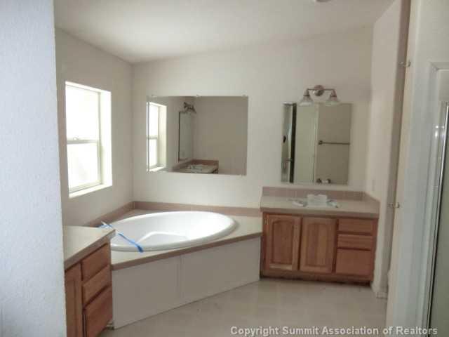865 Silver Creek Road Idaho Springs, CO 80452 - Photo 11 of 11 a bathroom with a tub sink and mirror