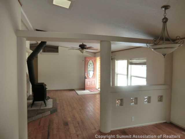 865 Silver Creek Road Idaho Springs, CO 80452 - Photo 3 of 11 a view of a hallway with wooden floor and staircase