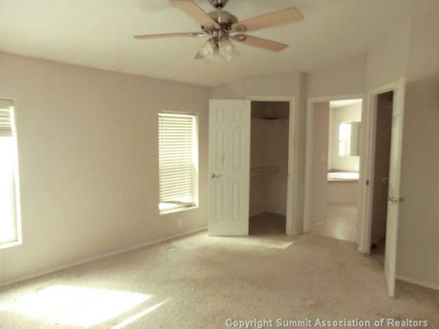 865 Silver Creek Road Idaho Springs, CO 80452 - Photo 6 of 11 an empty room with windows and fan